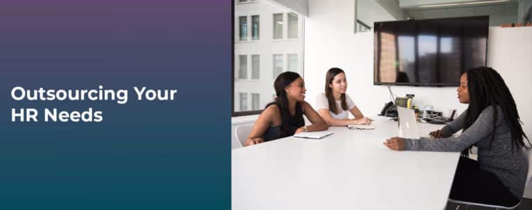 3 women at desk meeting